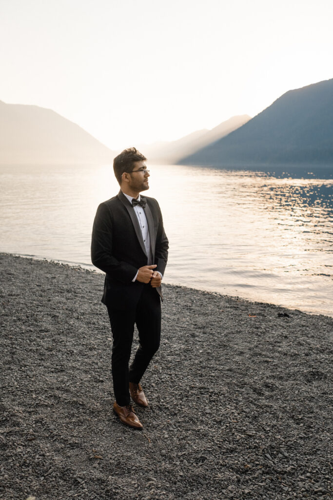 Groom waits for the bride on the Lake Crescent shore