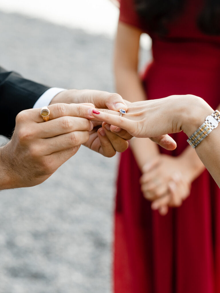Bride slips the ring onto the bride's finger