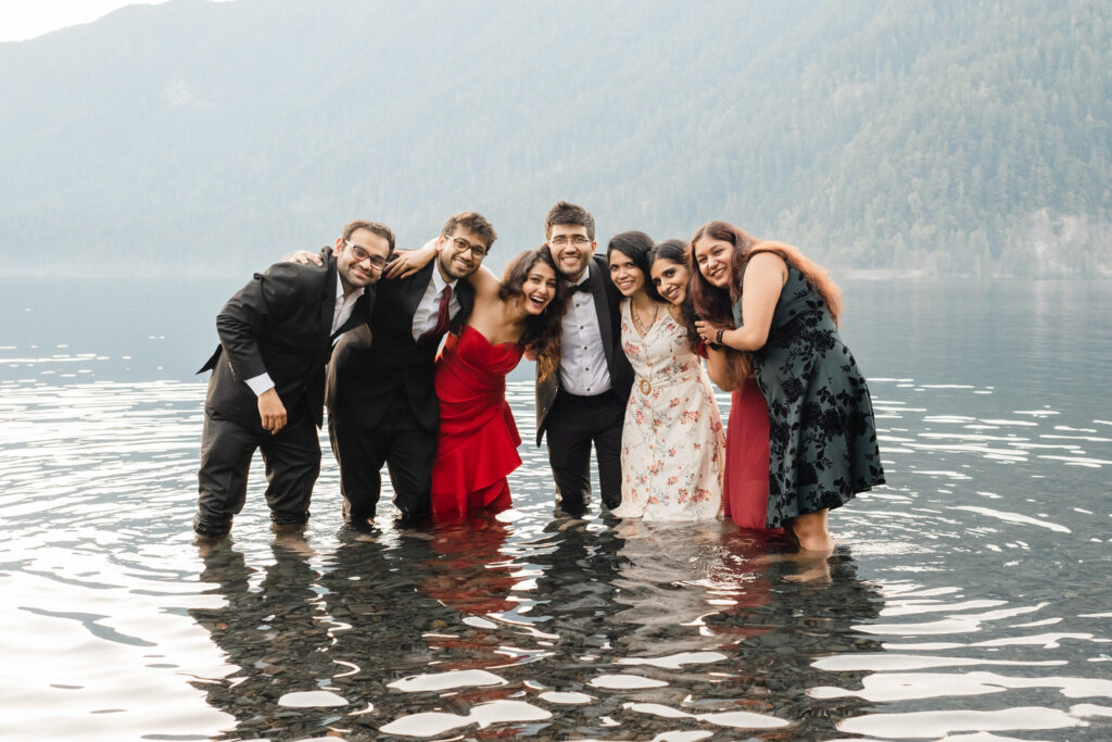 Bridal party takes a group photo in Lake Crescent