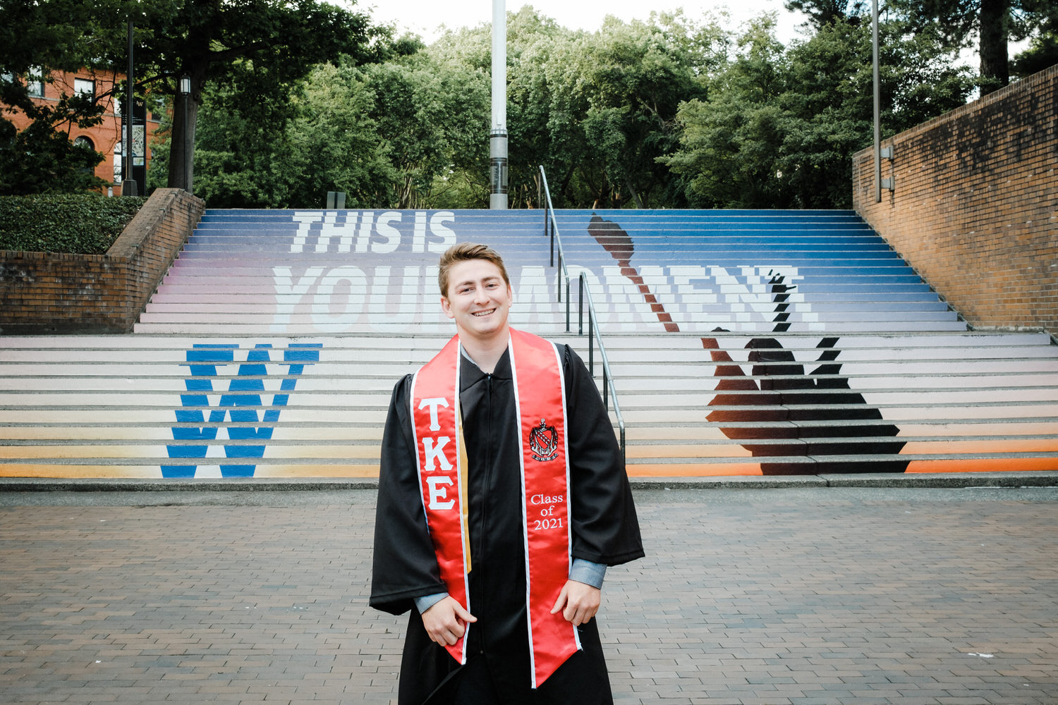 Smiling portrait of UW graduate in front of steps