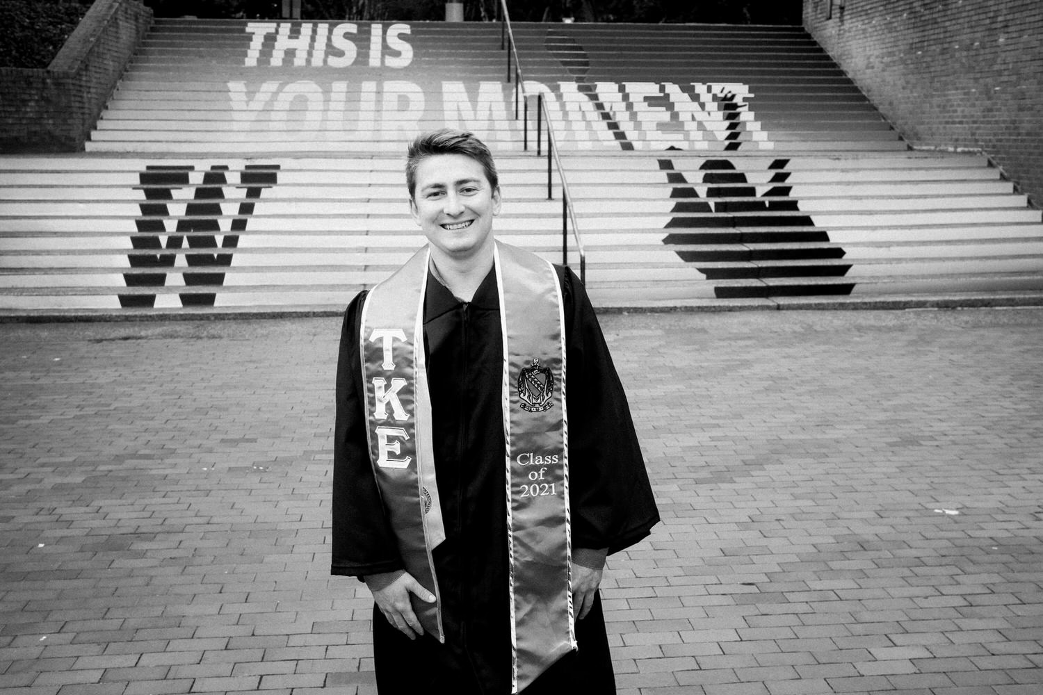 Black and white portrait of UW graduate in front of steps
