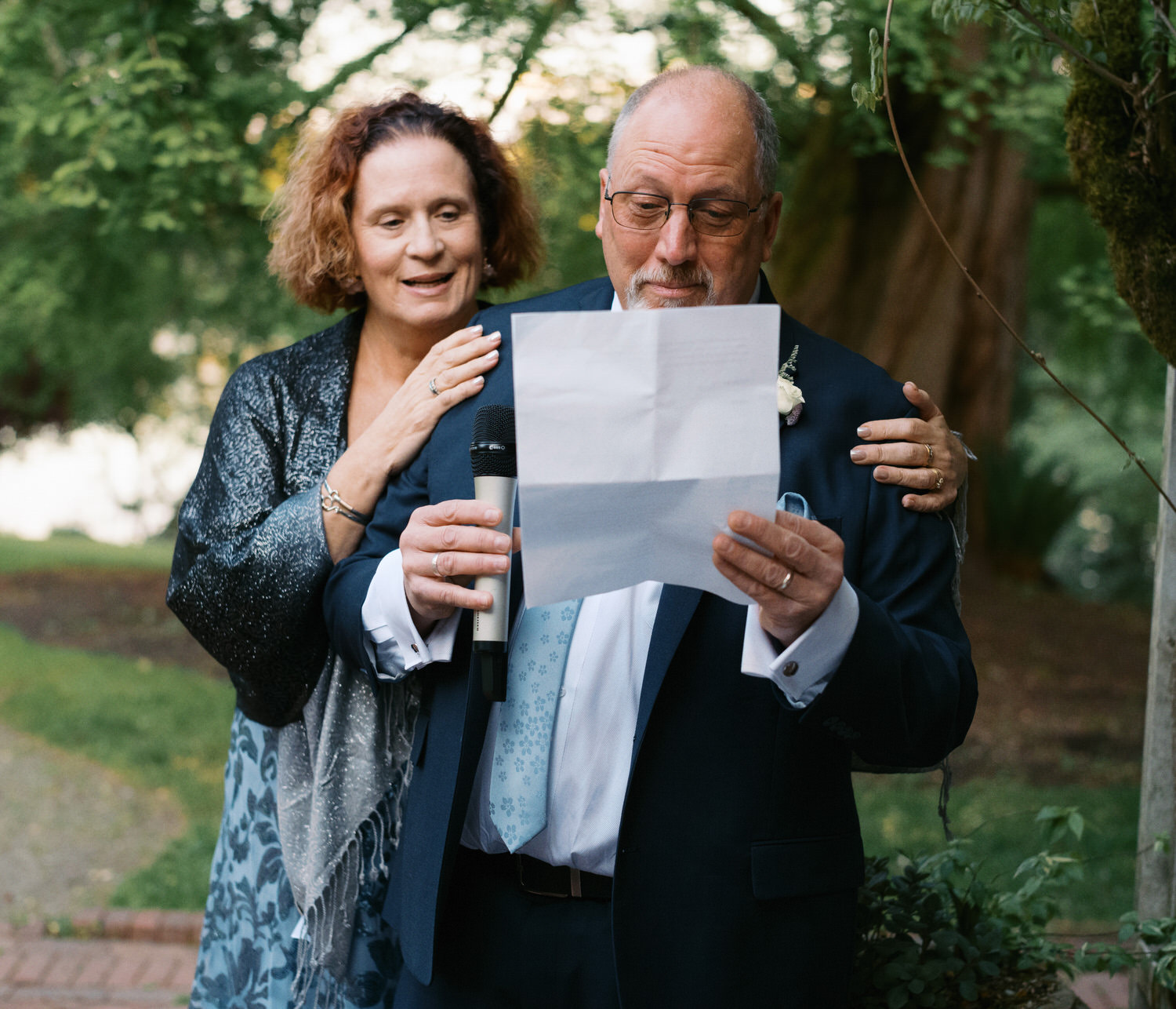 The Best Documentary Wedding Photography of 2025 9 A father reads a handwritten letter during an outdoor wedding ceremony