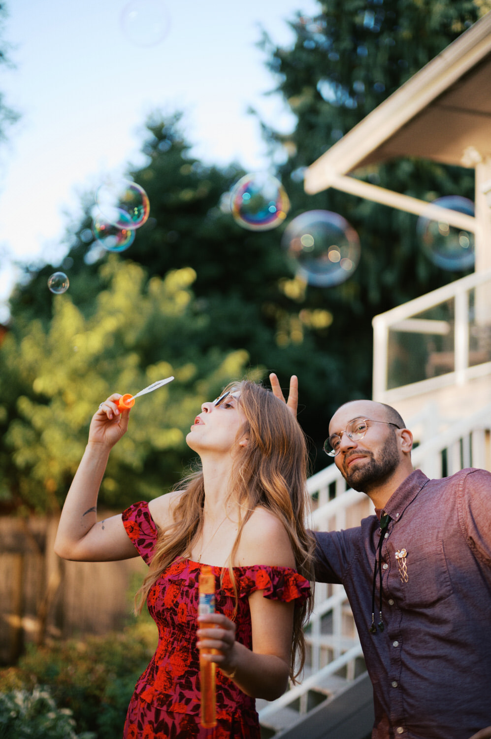 The Best Documentary Wedding Photography of 2025 18 The maid of honor blows bubbles in an outdoor wedding reception