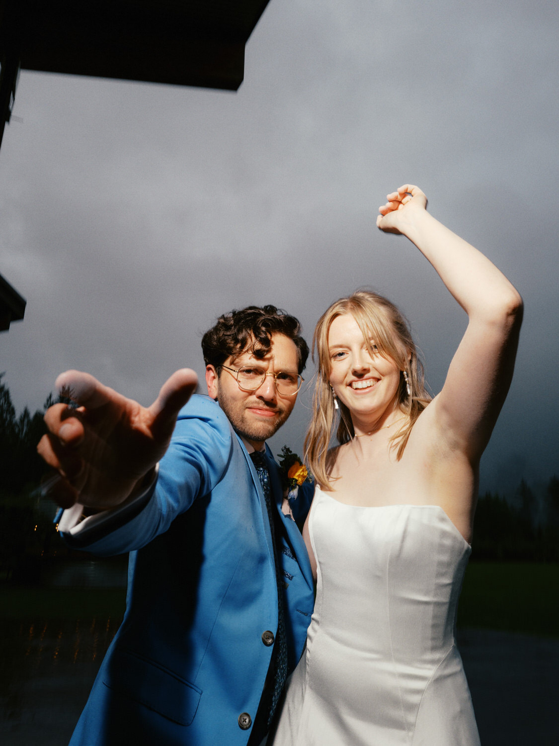 The Best Documentary Wedding Photography of 2025 20 Bride and groom raise their arms toward the camera just after sunset