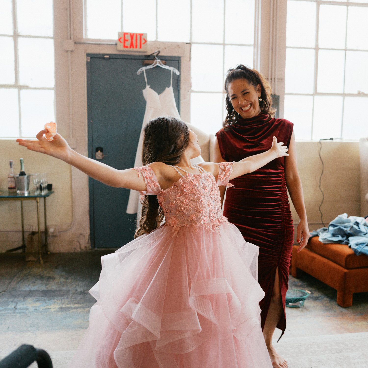 The Best Documentary Wedding Photography of 2025 21 A flower girl twirls in a pink dress while an adult smiles nearby
