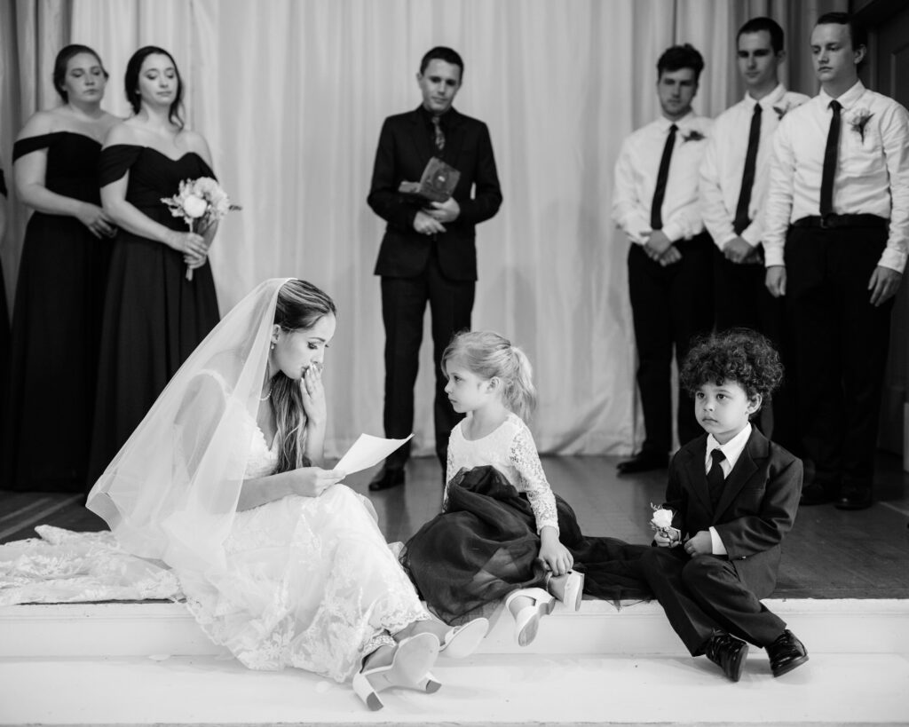 An emotional bride reads a set of specialty written vows to her new step-children