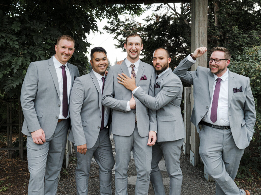 Groom and groomsmen pose for a group portrait