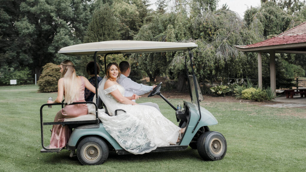 Bride catches a ride on a golf cart
