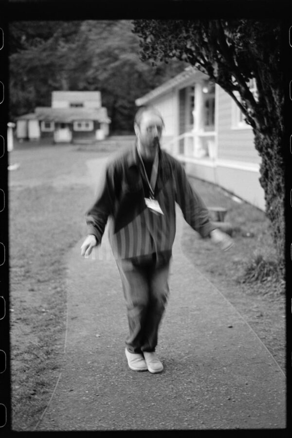 Olympic National Park Wedding | Sara and Robert's Summer Camp Wedding Weekend at NatureBridge 11 Black and white motion blur of guest walking along cabin path at NatureBridge Olympic summer camp wedding weekend
