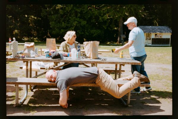Olympic National Park Wedding | Sara and Robert's Summer Camp Wedding Weekend at NatureBridge 17 Wedding guests gathered around picnic table during casual outdoor wedding weekend at summer camp