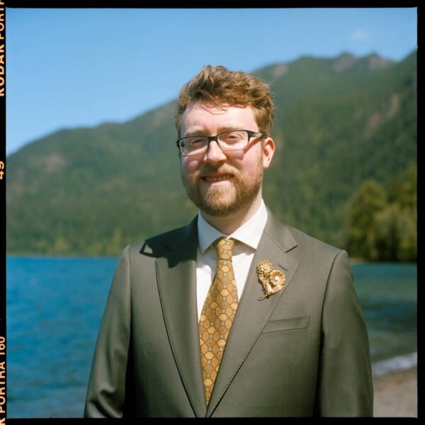 Olympic National Park Wedding | Sara and Robert's Summer Camp Wedding Weekend at NatureBridge 21 Portrait of groom at Lake Crescent during outdoor wedding in Olympic National Park