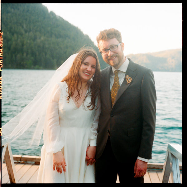 Olympic National Park Wedding | Sara and Robert's Summer Camp Wedding Weekend at NatureBridge 39 Bride and groom portrait on dock at sunset after lakeside wedding ceremony