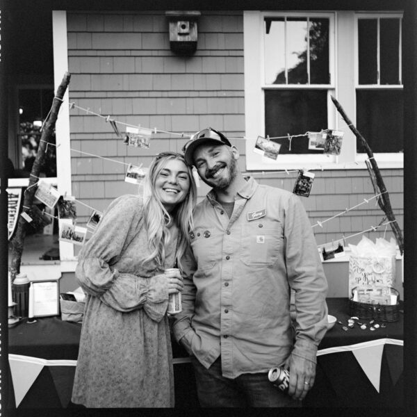 Olympic National Park Wedding | Sara and Robert's Summer Camp Wedding Weekend at NatureBridge 38 Black and white portrait of wedding guests smiling at reception inside summer camp lodge