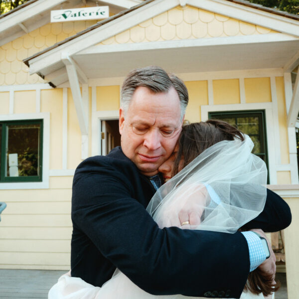 Olympic National Park Wedding | Sara and Robert's Summer Camp Wedding Weekend at NatureBridge 26 Emotional embrace between bride and parent outside cabin before wedding ceremony
