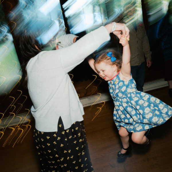 Olympic National Park Wedding | Sara and Robert's Summer Camp Wedding Weekend at NatureBridge 45 Child dancing with family member on reception dance floor during summer camp wedding