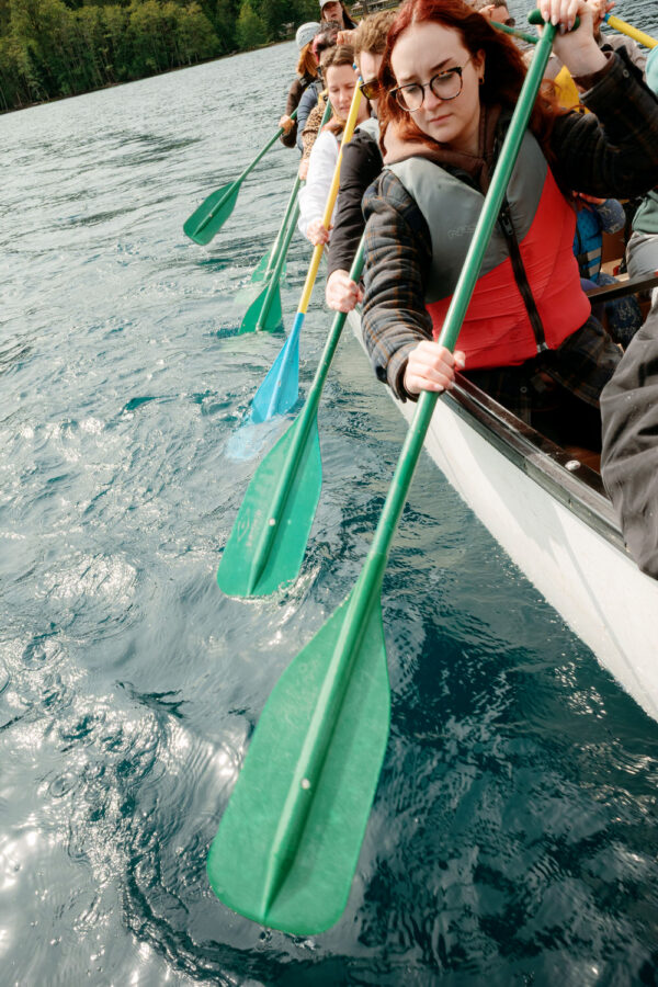 Olympic National Park Wedding | Sara and Robert's Summer Camp Wedding Weekend at NatureBridge 62 Wedding guests paddling canoe across Lake Crescent during post-wedding adventure