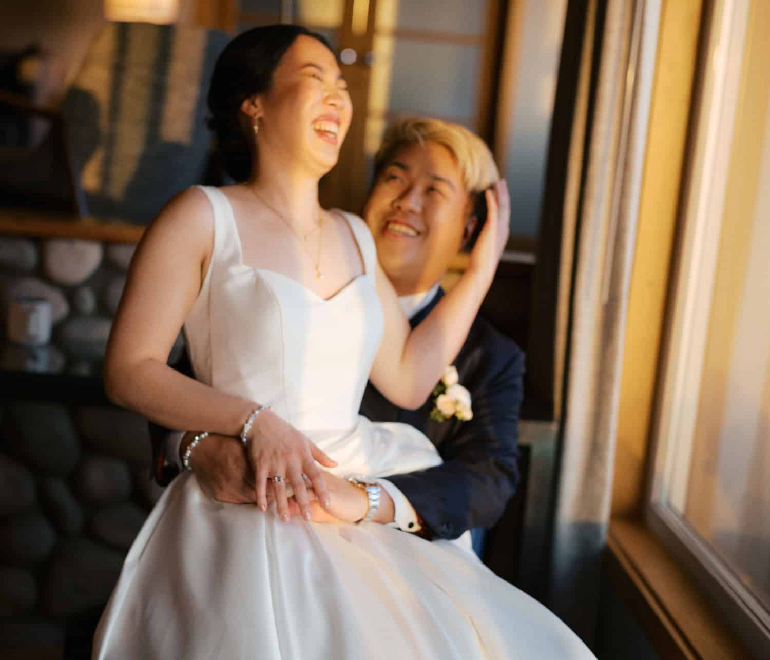The Edgewater Hotel Wedding | Candid Seattle Wedding Photography for Amy & Mike 24 Amy and Mike laughing together inside their Edgewater Hotel suite, bathed in golden hour light