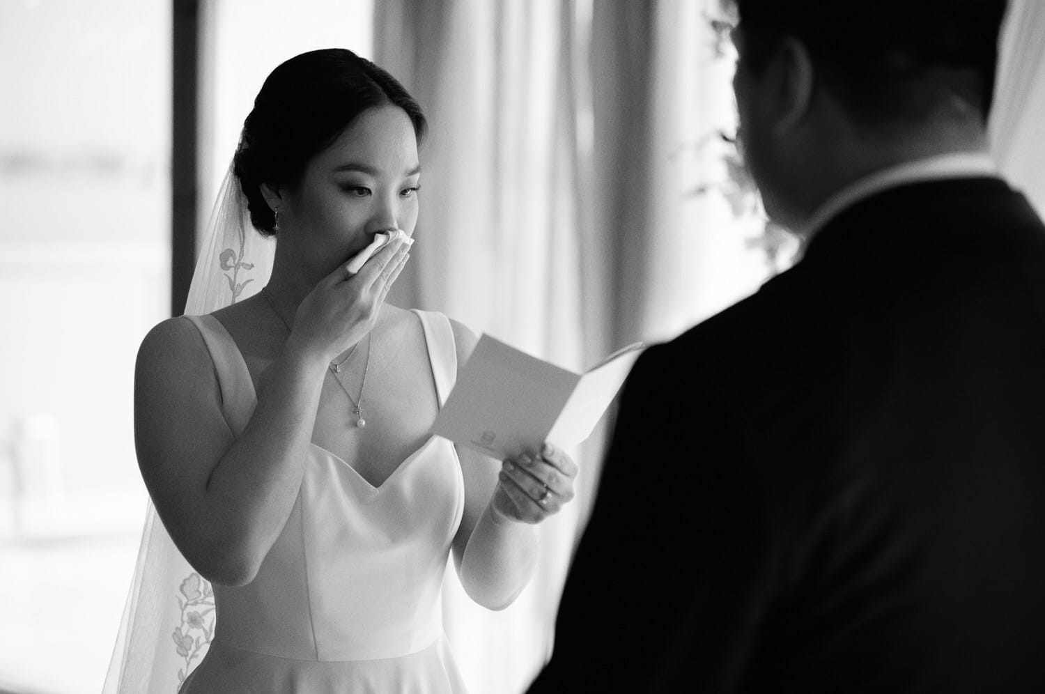 The Edgewater Hotel Wedding | Candid Seattle Wedding Photography for Amy & Mike 17 The bride reading her vows to the groom at their Edgewater Hotel wedding ceremony in Seattle, WA