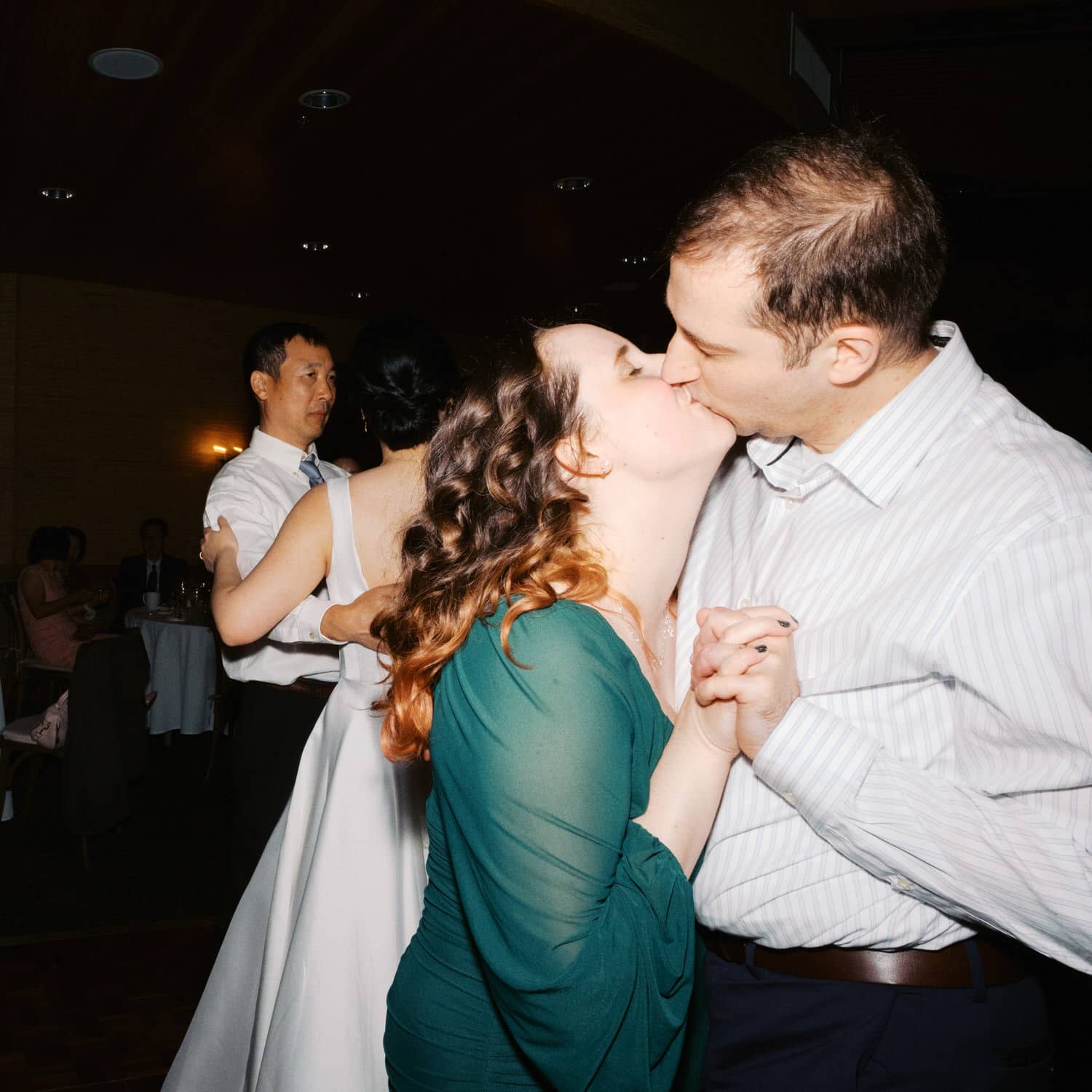 The Edgewater Hotel Wedding | Candid Seattle Wedding Photography for Amy & Mike 36 Guests sharing a kiss on the dance floor during Amy and Mike’s Edgewater Hotel wedding reception