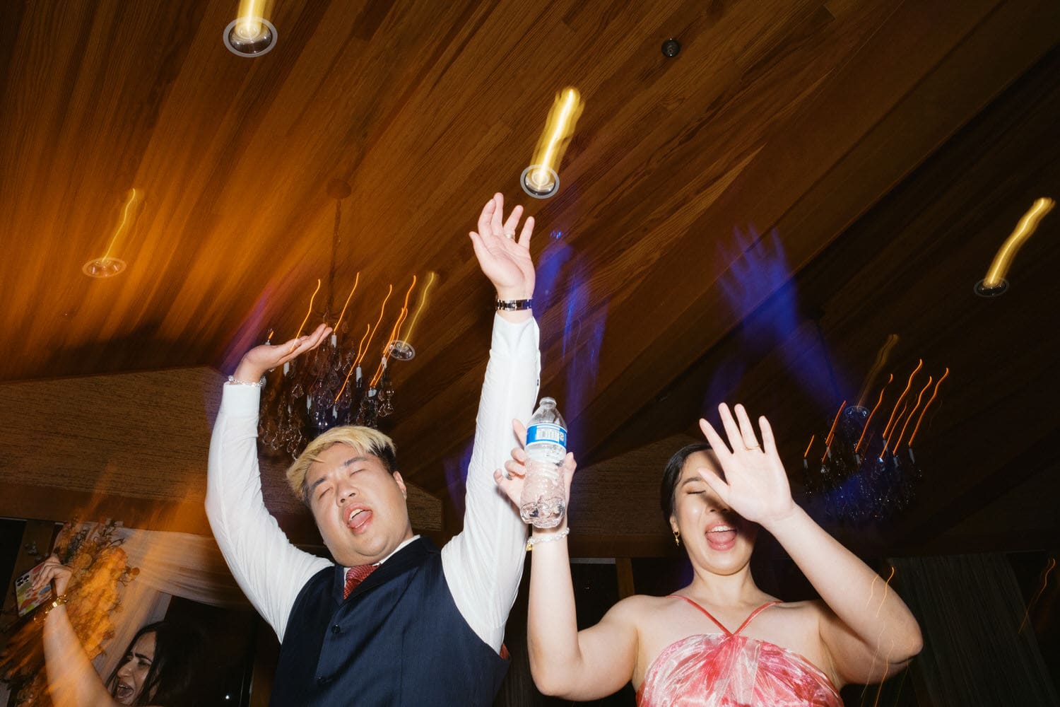 The Edgewater Hotel Wedding | Candid Seattle Wedding Photography for Amy & Mike 40 Bride and Groom raising their hands and celebrating on the dance floor at the Edgewater Hotel