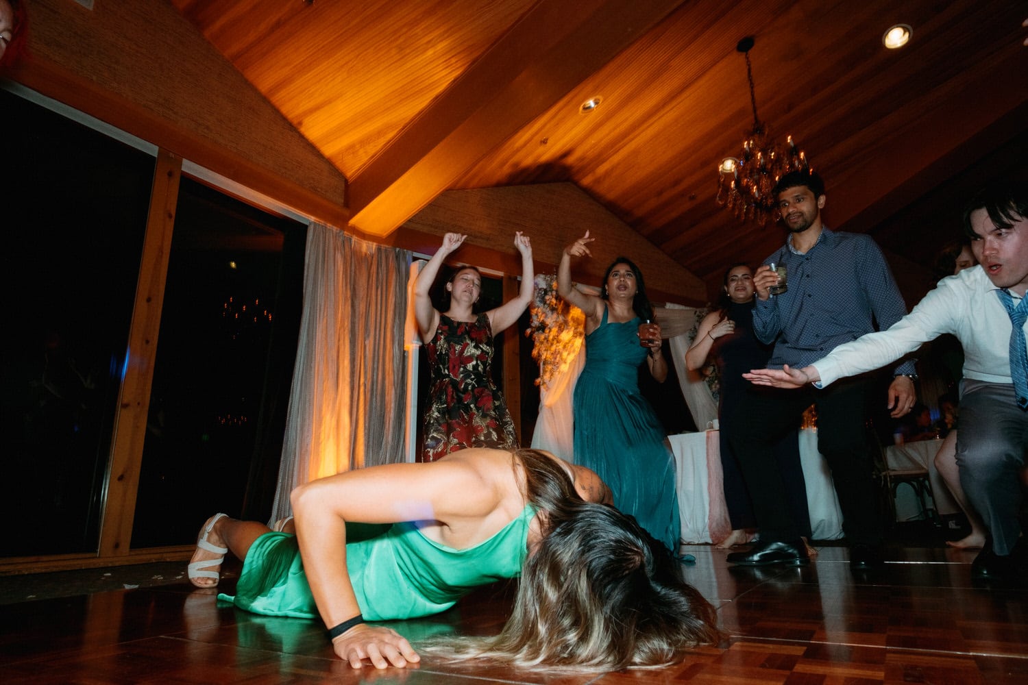 The Edgewater Hotel Wedding | Candid Seattle Wedding Photography for Amy & Mike 33 Wedding guest dancing on the floor while friends cheer during Amy and Mike’s Edgewater Hotel reception