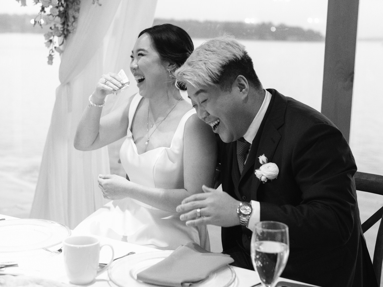 The Edgewater Hotel Wedding | Candid Seattle Wedding Photography for Amy & Mike 26 The couple laughing together during speeches at their Edgewater Hotel reception overlooking Elliott Bay